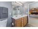 The remodeled bathroom features a dual-sink vanity and framed mirror, offering plenty of storage and prep space at 3335 Hurst St, Whiteland, IN 46184