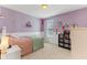 Charming bedroom with soft lavender walls, decorative accents, and cozy furnishings at 3335 Hurst St, Whiteland, IN 46184