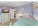 Comfortable bedroom featuring a dresser, closet, soft lighting, and a view of the entry at 3335 Hurst St, Whiteland, IN 46184