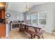 Bright dining area with farmhouse table and benches, complemented by modern lighting and tiled flooring at 3335 Hurst St, Whiteland, IN 46184