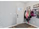 Well-lit entryway with a coat rack, modern flooring, and a glass paneled front door at 3335 Hurst St, Whiteland, IN 46184