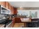 Charming kitchen offering stainless steel appliances, wood cabinetry, and a cozy breakfast bar at 3335 Hurst St, Whiteland, IN 46184