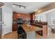 Inviting kitchen featuring wood cabinets, tile backsplash, and a center island with seating at 3335 Hurst St, Whiteland, IN 46184