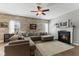 Inviting living room with a cozy fireplace, a ceiling fan, and lots of seating at 3335 Hurst St, Whiteland, IN 46184