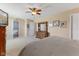 This spacious bedroom features a ceiling fan, and access to an ensuite bath and boasts neutral walls and carpet at 3335 Hurst St, Whiteland, IN 46184