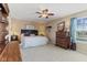 Serene main bedroom featuring a ceiling fan, plush carpet, and a view of the landscape at 3335 Hurst St, Whiteland, IN 46184