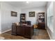 Home office with hardwood floors, built-in bookshelves, and stylish decor at 3335 Hurst St, Whiteland, IN 46184