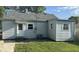 Rear view of a home featuring durable siding, a well-kept yard, and a back door entrance at 712 Lonsvale Dr, Anderson, IN 46013