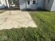 Exterior shot displaying a concrete patio and grassy area, great for outdoor activities and leisure at 712 Lonsvale Dr, Anderson, IN 46013