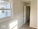 Bright bedroom featuring neutral walls, carpet, a bright window, and a white door at 712 Lonsvale Dr, Anderson, IN 46013