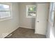Bedroom with two windows, neutral walls, carpet, and a white door at 712 Lonsvale Dr, Anderson, IN 46013