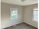 Cozy bedroom featuring neutral walls, carpet, and a bright window with a view of the neighborhood at 712 Lonsvale Dr, Anderson, IN 46013