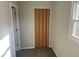 Bedroom with window, light colored walls, and a folding door at 712 Lonsvale Dr, Anderson, IN 46013
