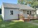 Cozy home with a wooden porch, complemented by neat landscaping and natural light at 712 Lonsvale Dr, Anderson, IN 46013
