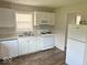 Bright kitchen features white cabinets, laminate countertops, and modern appliances at 712 Lonsvale Dr, Anderson, IN 46013