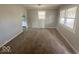 Inviting living room with neutral walls, carpet flooring, and ample natural light streaming through windows at 712 Lonsvale Dr, Anderson, IN 46013