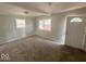 Bright living room featuring a large window, carpet floors, and fresh white trim at 712 Lonsvale Dr, Anderson, IN 46013
