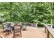 Large back deck features a grill and outdoor furniture, perfect for entertaining in a wooded setting at 14626 Warner Trl, Westfield, IN 46074