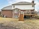 View of backyard with brick and siding exterior, wooden deck, wood fence, and wooden stairs leading to deck at 14626 Warner Trl, Westfield, IN 46074