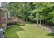 Lush backyard featuring a wooden deck, mature trees and a well-manicured lawn at 14626 Warner Trl, Westfield, IN 46074