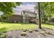Exterior of home with a spacious backyard featuring an elevated deck, landscaping, and lush lawn at 14626 Warner Trl, Westfield, IN 46074