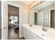 Bright bathroom featuring a dual sink vanity and a view into an adjacent bedroom at 14626 Warner Trl, Westfield, IN 46074
