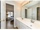 Bathroom with double vanity, great lighting, and an open door with a view to the bedroom at 14626 Warner Trl, Westfield, IN 46074