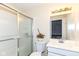 Bright bathroom featuring a shower with sliding glass doors, modern vanity, and tiled walls at 14626 Warner Trl, Westfield, IN 46074