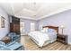 Primary bedroom featuring a tray ceiling, sitting area, chandelier, and hardwood floors at 14626 Warner Trl, Westfield, IN 46074