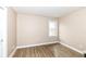 Bedroom features wood floors, a large window, and neutral colored walls at 14626 Warner Trl, Westfield, IN 46074
