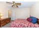 Cozy bedroom with a floral comforter, a ceiling fan, and an open door to another room at 14626 Warner Trl, Westfield, IN 46074