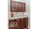 Butler pantry area with granite countertops and wood cabinets at 14626 Warner Trl, Westfield, IN 46074