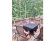 Spacious wooden deck with outdoor seating, surrounded by mature trees and lush greenery at 14626 Warner Trl, Westfield, IN 46074