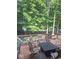 Outdoor deck featuring metal chairs and table with mature trees and view of the green lawn beyond the fence at 14626 Warner Trl, Westfield, IN 46074