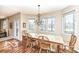 Bright dining room with wood floors, chandelier, many windows and a wood table at 14626 Warner Trl, Westfield, IN 46074