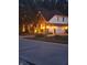 Well-lit two-story home showcases a brick facade, an attached two-car garage, and manicured landscaping at 14626 Warner Trl, Westfield, IN 46074