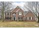 Charming two-story brick home featuring black shutters, arched window, and well-manicured lawn at 14626 Warner Trl, Westfield, IN 46074