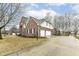 Two-story brick and siding home with a long driveway, two-car garage, and a basketball hoop at 14626 Warner Trl, Westfield, IN 46074