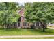 Charming brick two-story home with landscaped front yard and mature trees at 14626 Warner Trl, Westfield, IN 46074