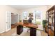 Bright home office featuring wood desk, shelving, and french doors to living area at 14626 Warner Trl, Westfield, IN 46074