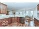 Bright kitchen with island seating, stainless dishwasher, and adjacent dining area at 14626 Warner Trl, Westfield, IN 46074