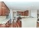Well-equipped kitchen with stainless steel appliances, granite countertops, and wood cabinets at 14626 Warner Trl, Westfield, IN 46074