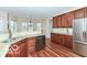 Spacious kitchen featuring stainless appliances, granite countertops, and wood cabinetry at 14626 Warner Trl, Westfield, IN 46074
