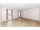 Spacious living room with wood-look flooring and large windows with red patterned curtains at 14626 Warner Trl, Westfield, IN 46074