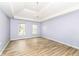 Spacious main bedroom featuring wood floors, tray ceiling, and bright windows at 14626 Warner Trl, Westfield, IN 46074