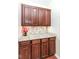 Pantry features granite countertop, tile backsplash, and ample wood cabinet storage space at 14626 Warner Trl, Westfield, IN 46074