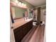 Bathroom featuring brown cabinets, a large mirror, and a shower with curtain at 5656 Buck Dr, Noblesville, IN 46062