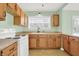 Modern kitchen featuring wood cabinets and white appliances at 2601 Davis Rd, Indianapolis, IN 46239