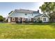 Expansive backyard featuring a stone patio with seating, perfect for outdoor entertaining and relaxation at 1487 Brook Mill Ct, Carmel, IN 46032