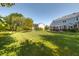 Spacious backyard featuring lush lawn and mature trees, creating a serene and private outdoor space with a pond at 1487 Brook Mill Ct, Carmel, IN 46032